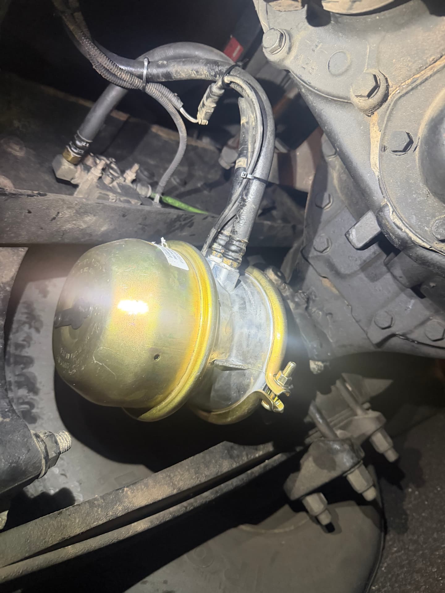 New brake chamber installed on a heavy-duty truck axle