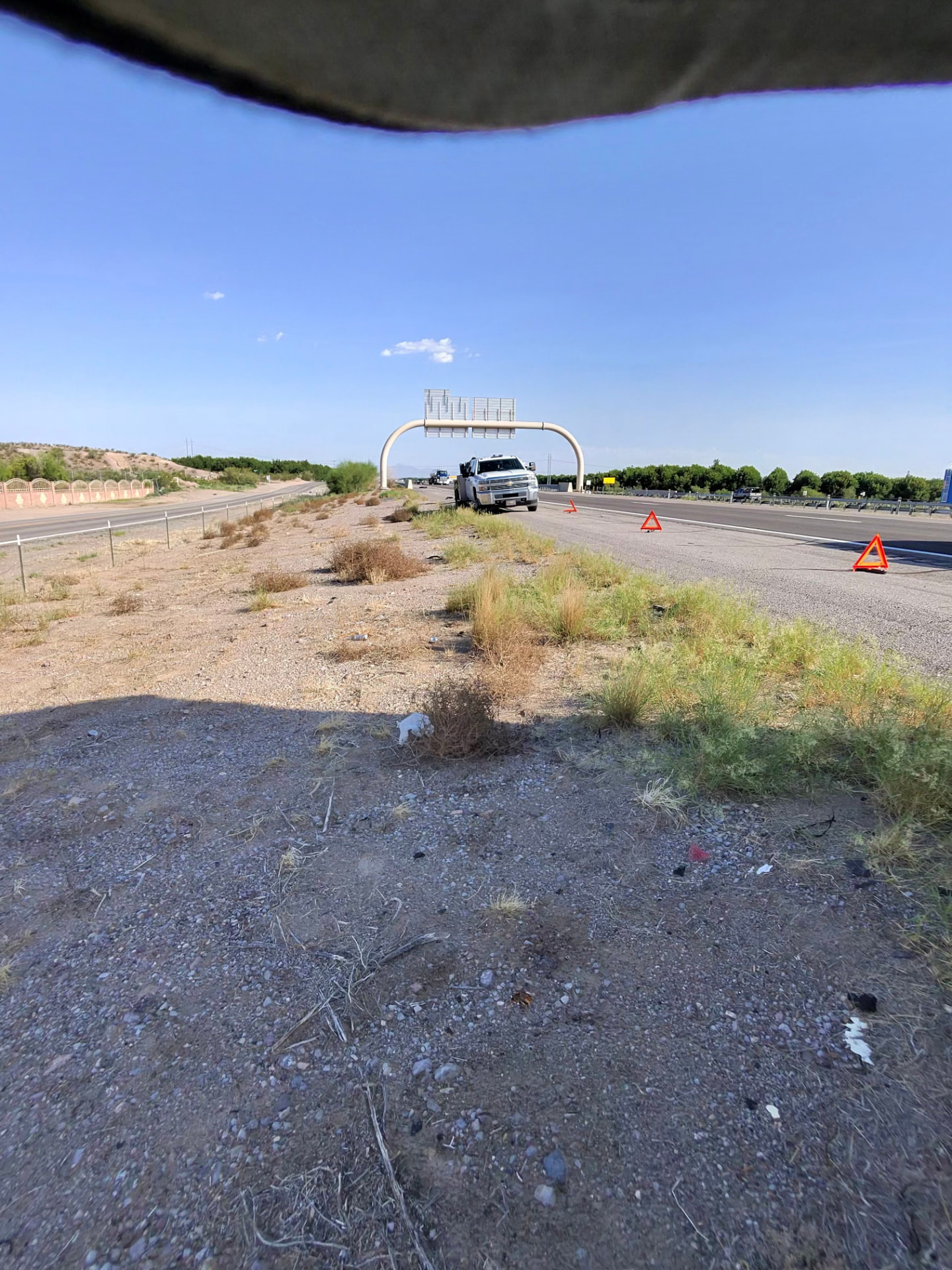 Roadside service call on the interstate shoulder with warning triangles